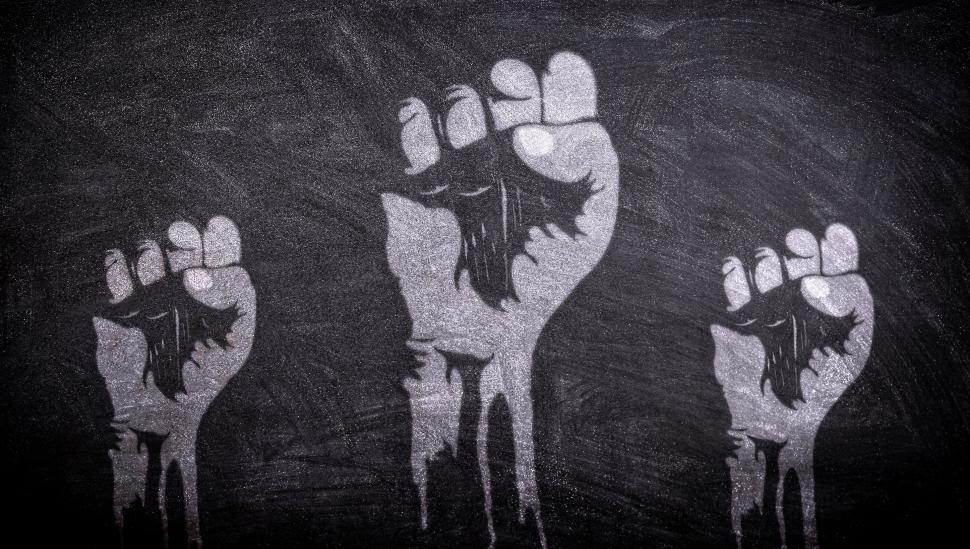 Free Image of Power to the People - Raised Fists on Blackboard 