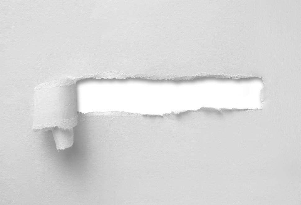 Free Image of A wide hole ripped through paper sheet 