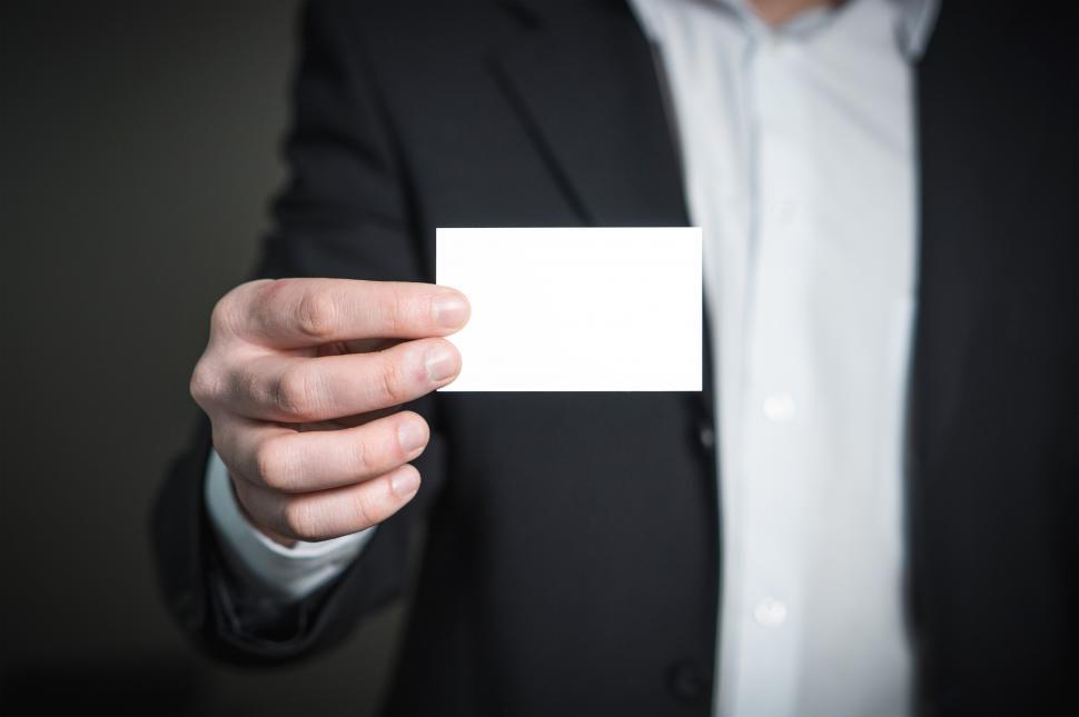 Free Image of A hand holding a blank business card 