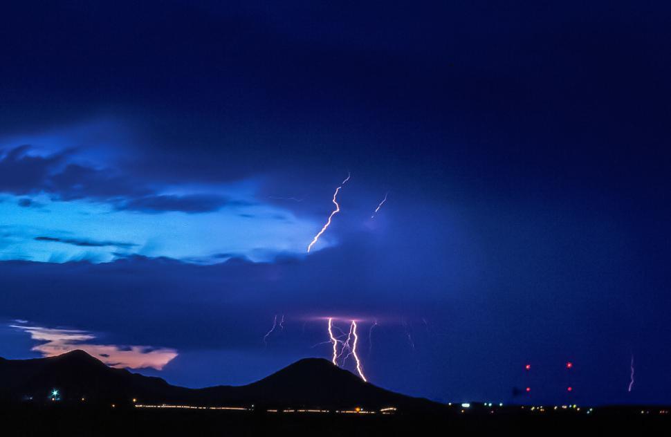 Free Image of Lightning over mountains and city 