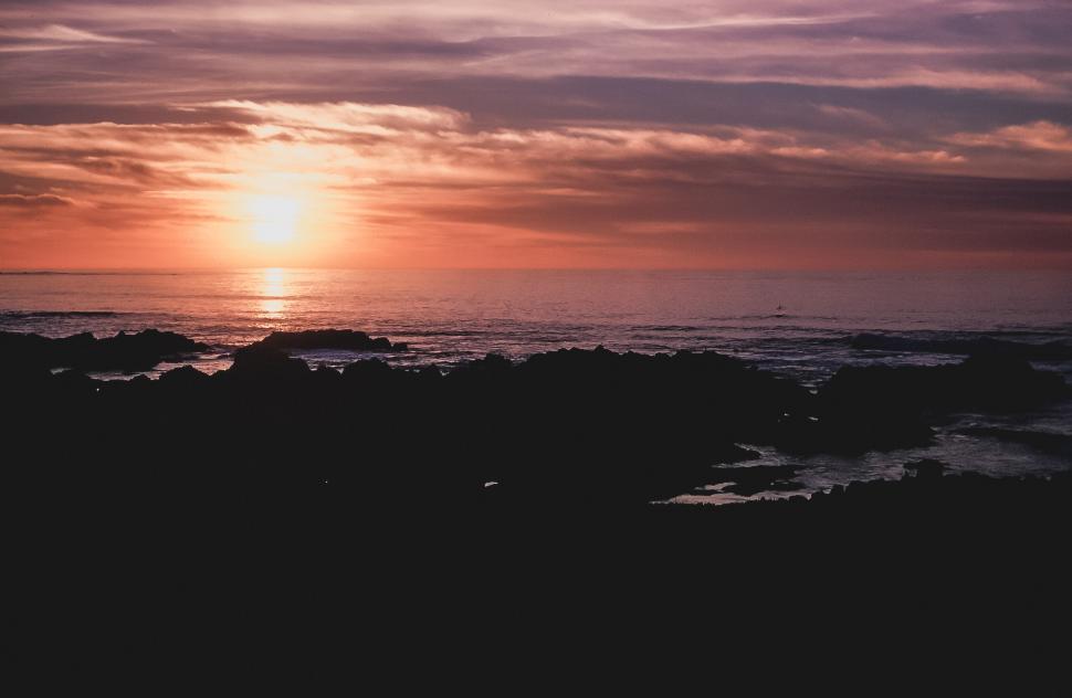 Free Image of Sunset Shines Over Rocky Shore 