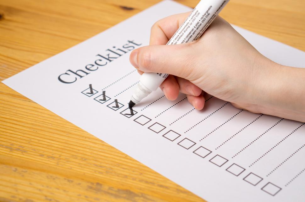 Free Image of Side view of a hand writing on a checklist 