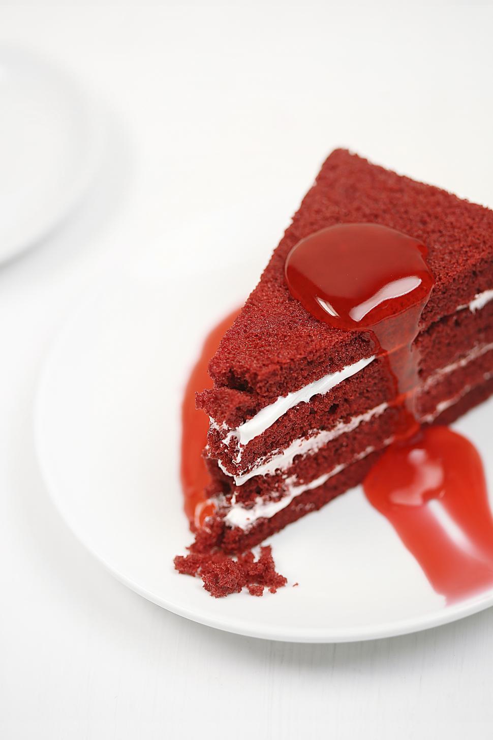 Free Image of Close-up of Red Velvet sponge cake slice with cream on top 