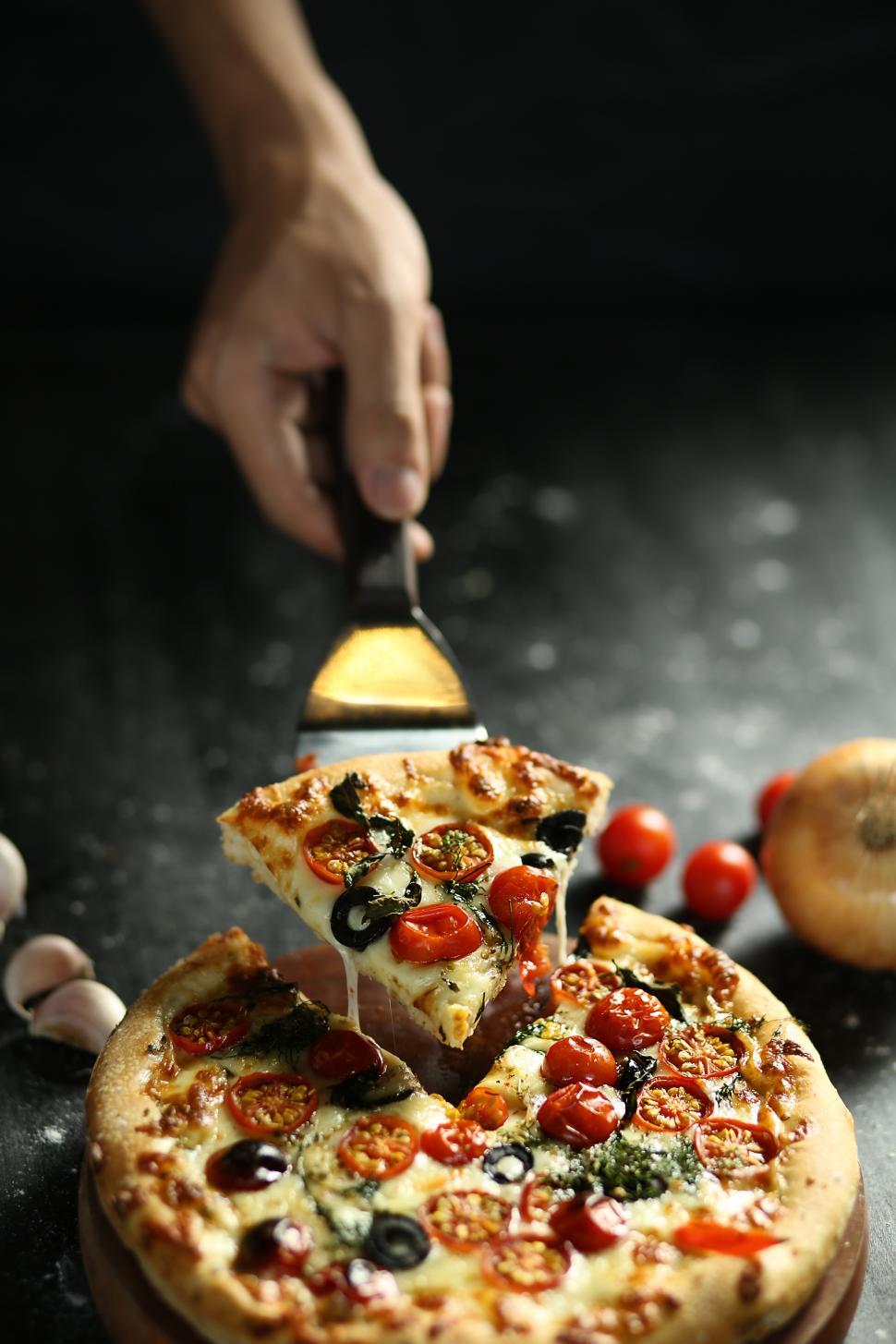 Free Image of Taking piece of pizza 