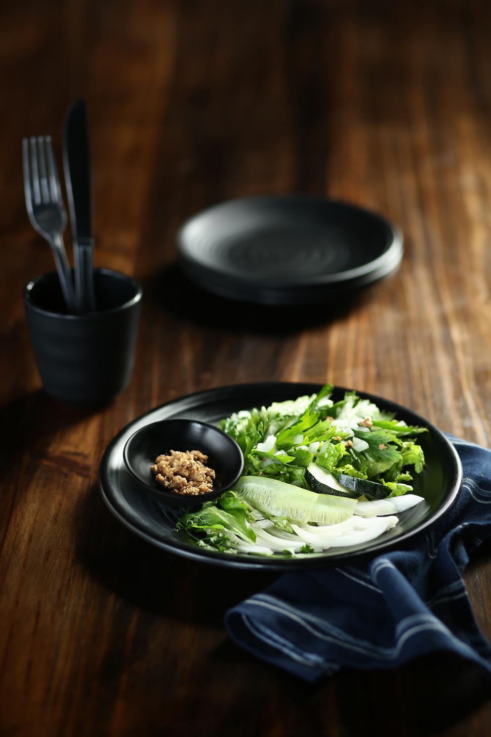 Free Image of Lettuce salad on black serving plate 