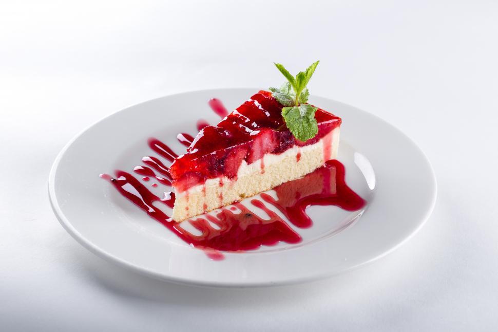 Free Image of Cake garnished with strawberry sauce 