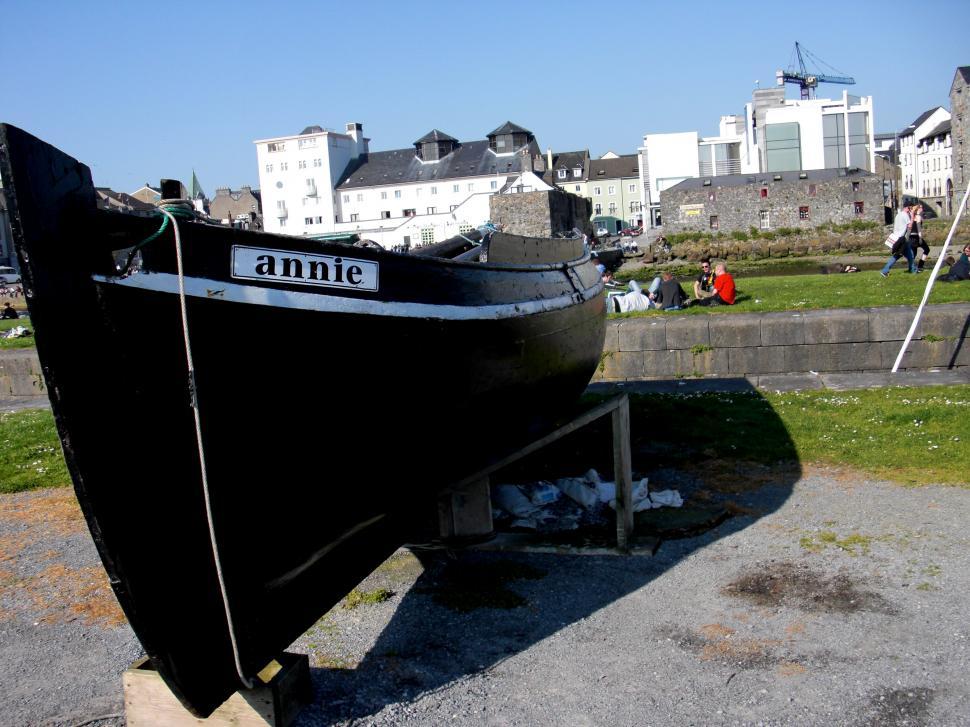 Free Image of Black Boat Resting on Cement Ground 