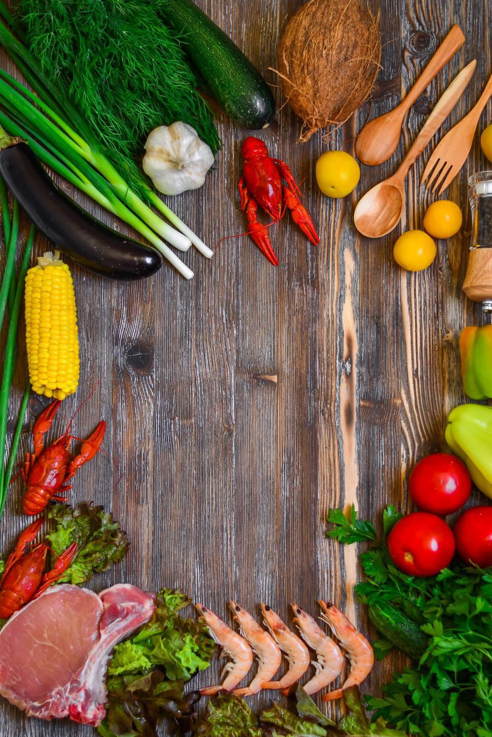 Free Image of Vegetables and seafood arranged on a hardwood board 