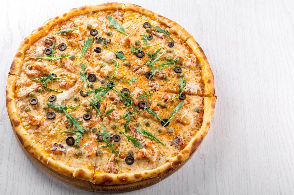 Free Image of Baked Pizza on wooden plate 