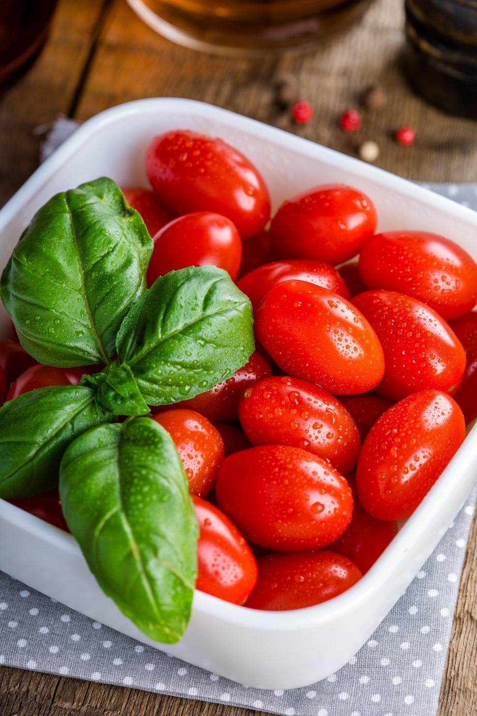 Free Image of Bright red tomatoes and basil leaves 