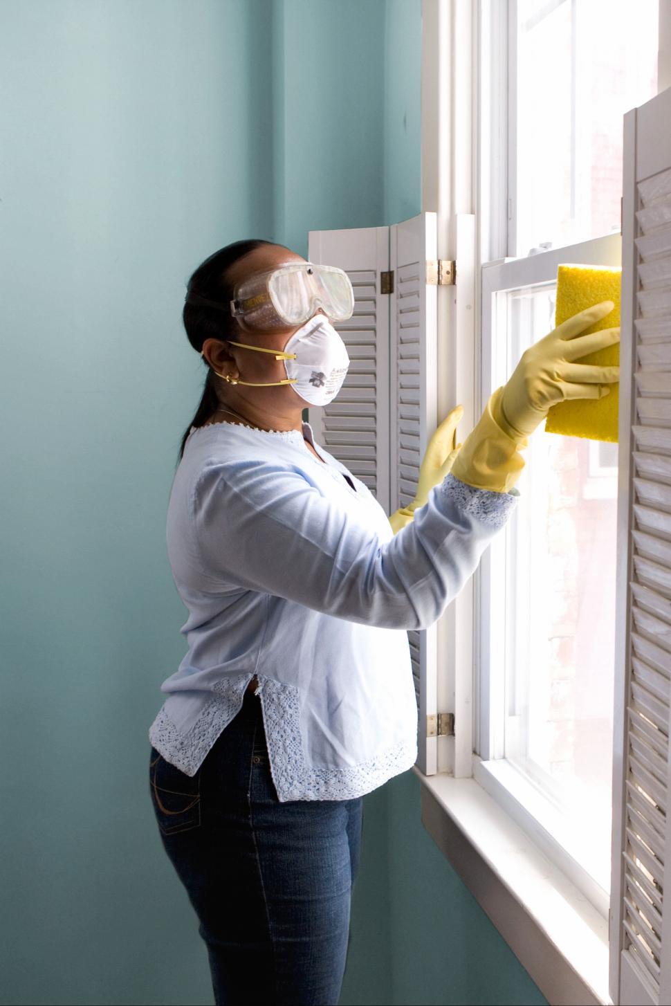 Free Image of Woman in mask and gloves disinfecting surfaces 