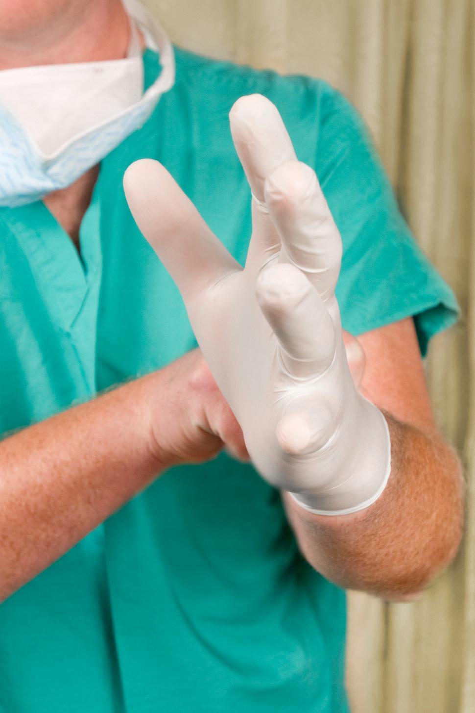 Free Image of Medical Provider Putting on Gloves 