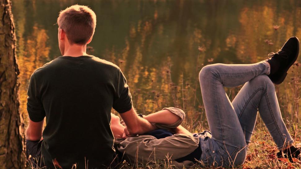 Free Image of Young couple lounging in the forest 