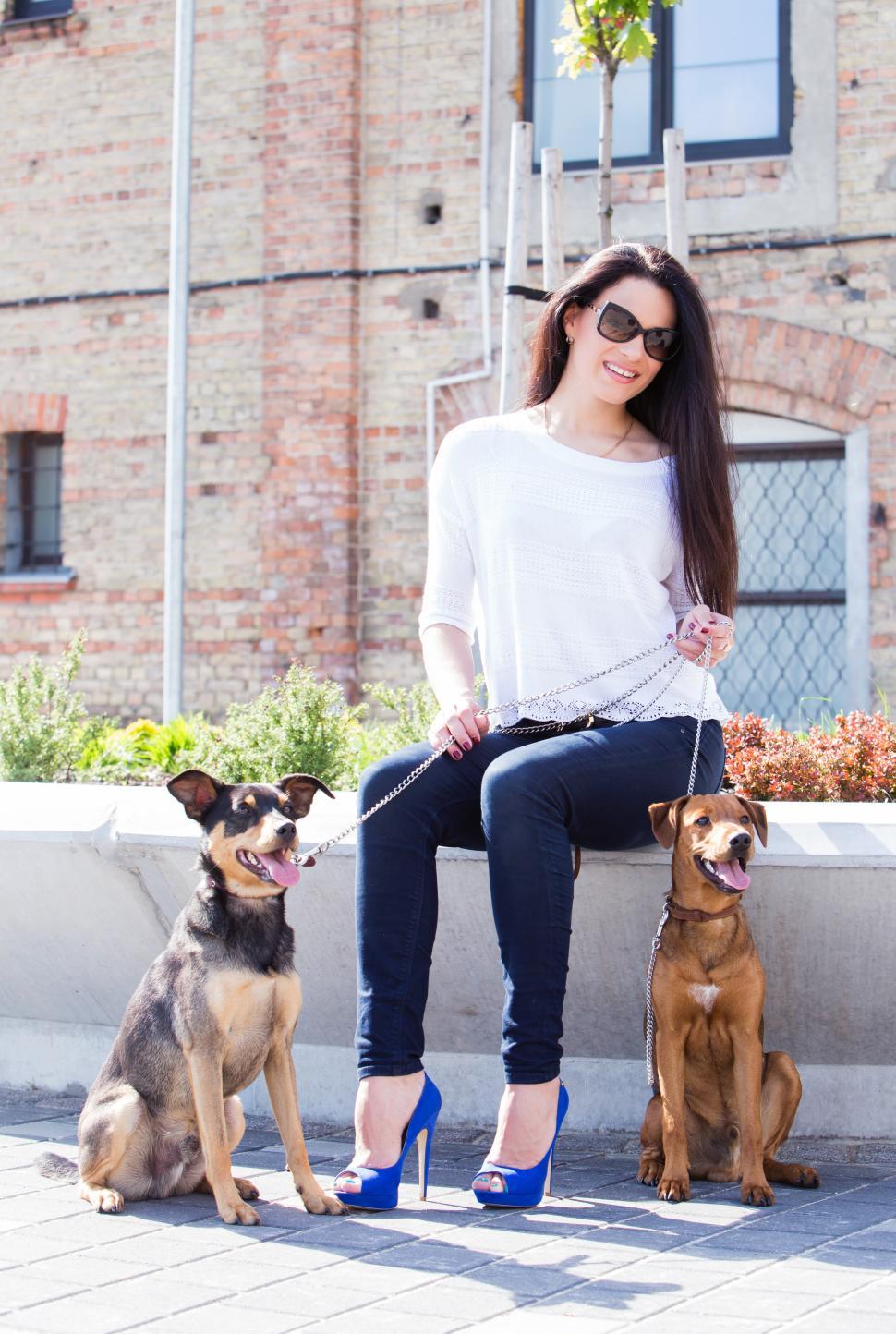 Download Free Stock Photo of Beautiful woman in city with dogs 