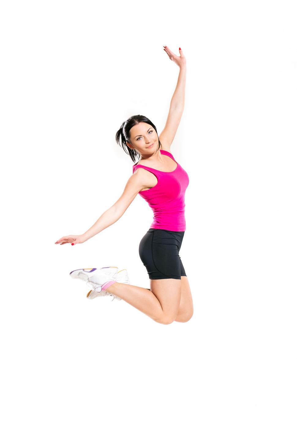 Free Image of Brunette on a white background leaping 