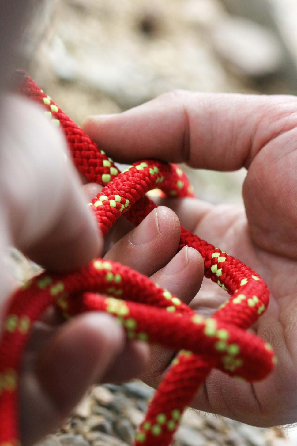 Free Image of Hands working on a rope and knot 