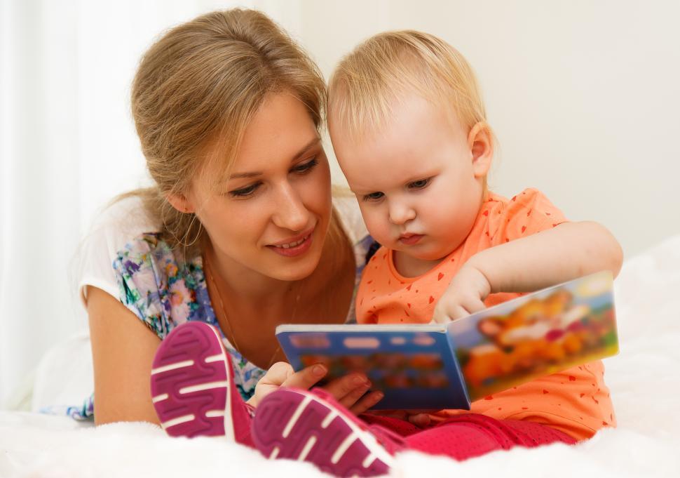 Free Image of Mother and her child reading a book 