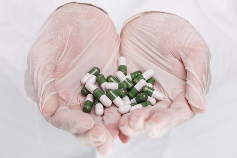 Free Image of Doctor holding heap of pills 