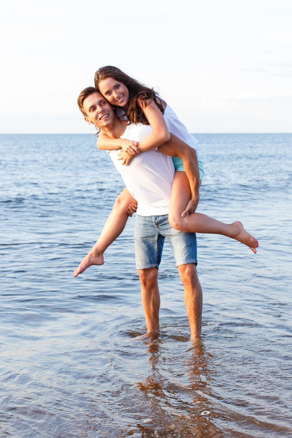 Free Image of Beautiful couple playing in the surf 