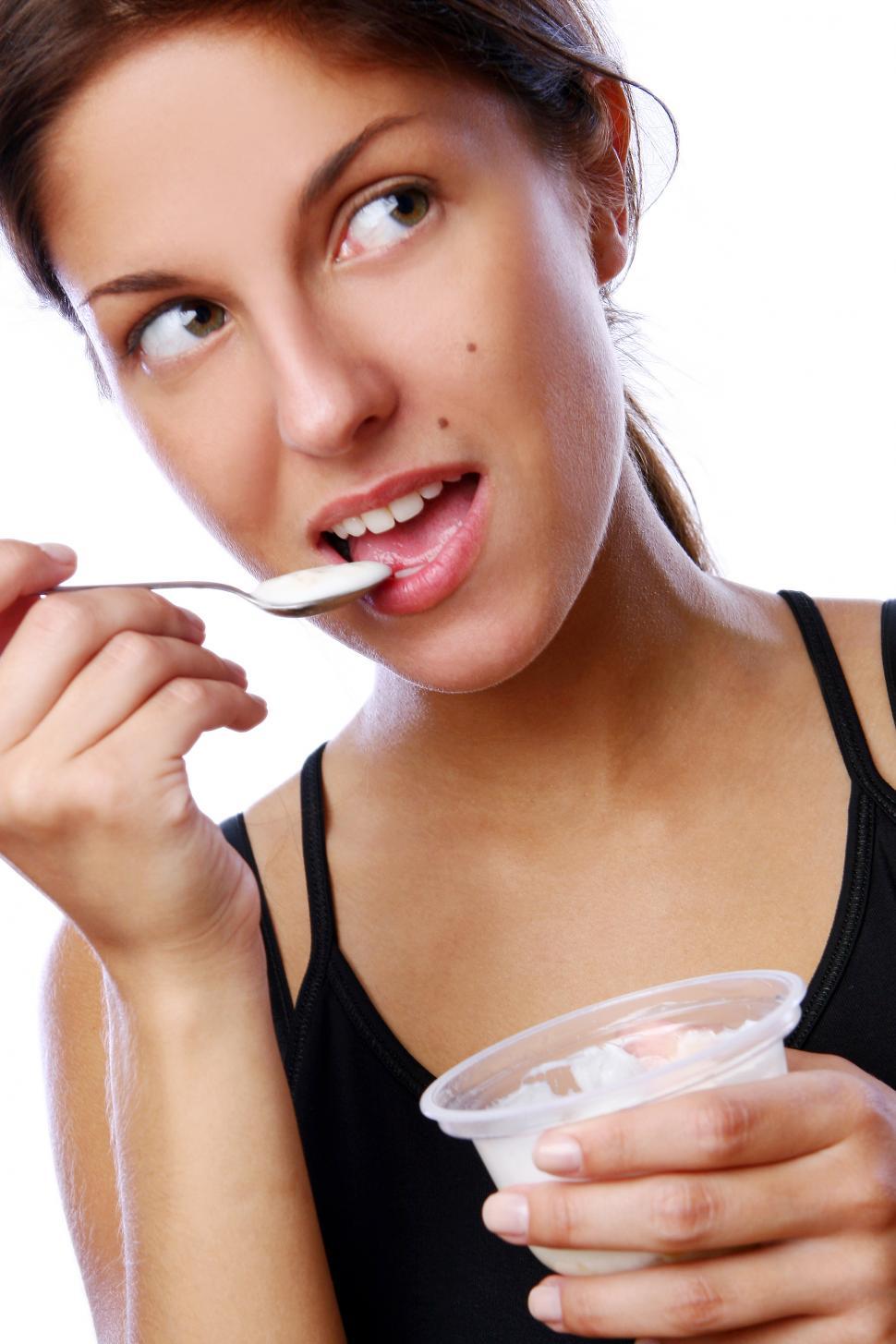 Free Image of young woman eating yogurt 