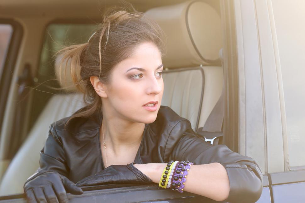 Free Image of Cool girl in window of a car 