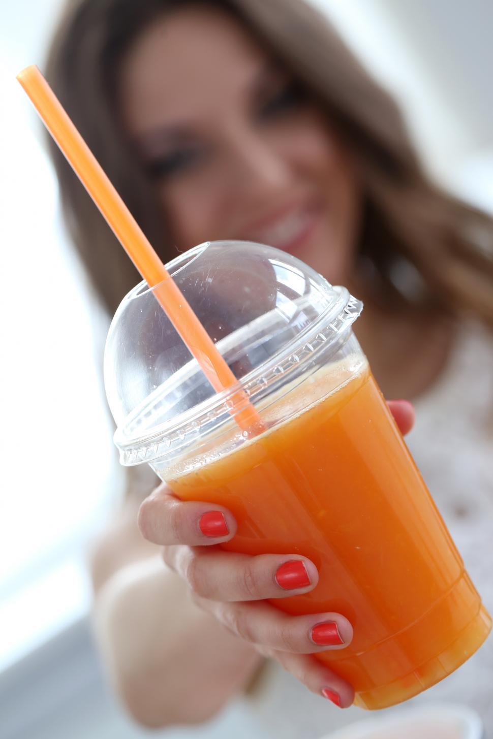 Free Image of Beautiful girl with orange juice 