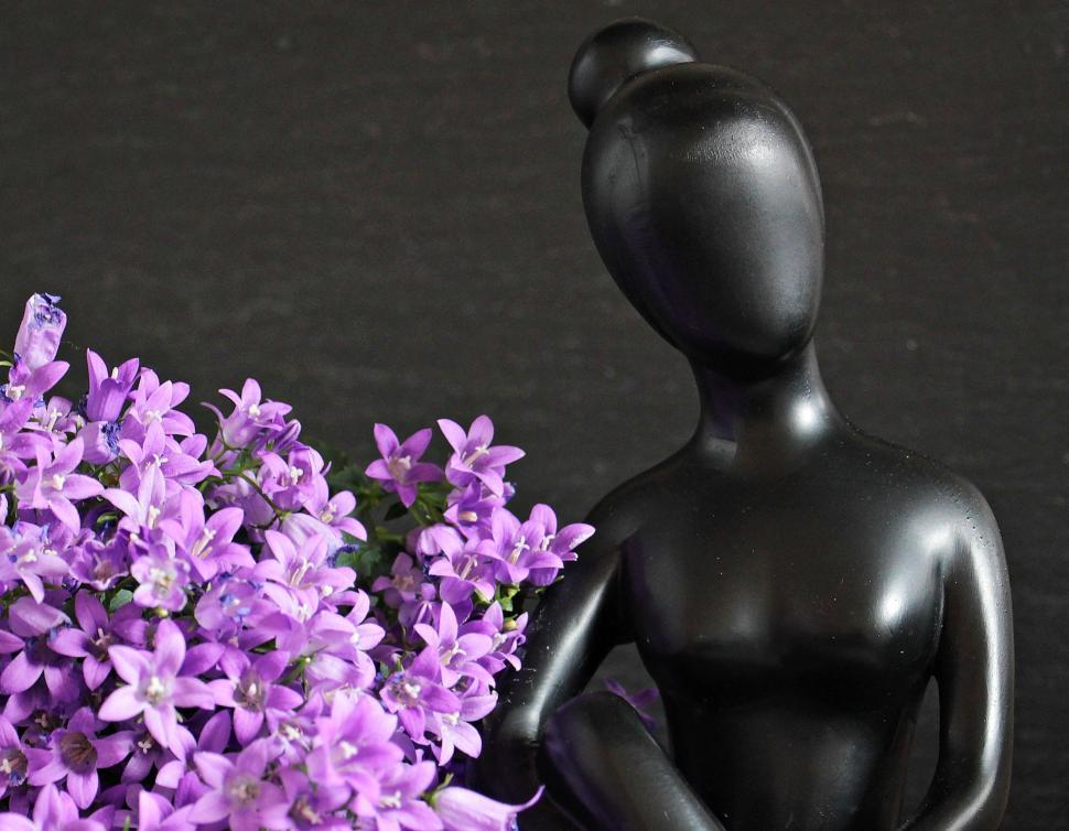Free Image of Sculpture and flowers 
