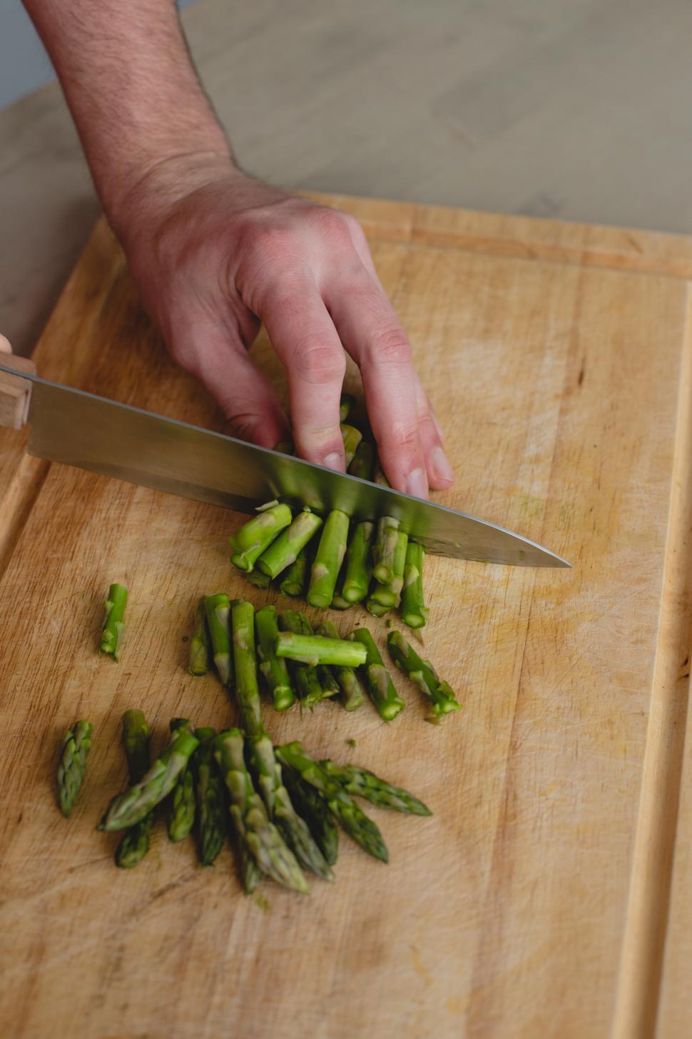 Free Image of Man chopping asparagus 