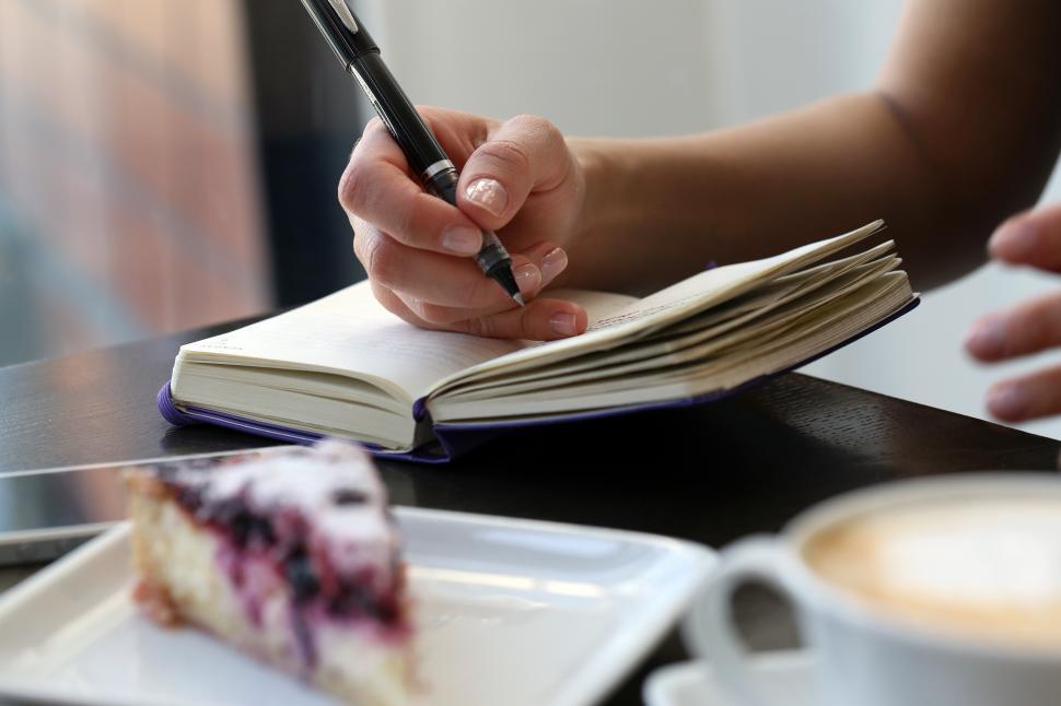 Free Image of Restaurant. Writing in a notebook 