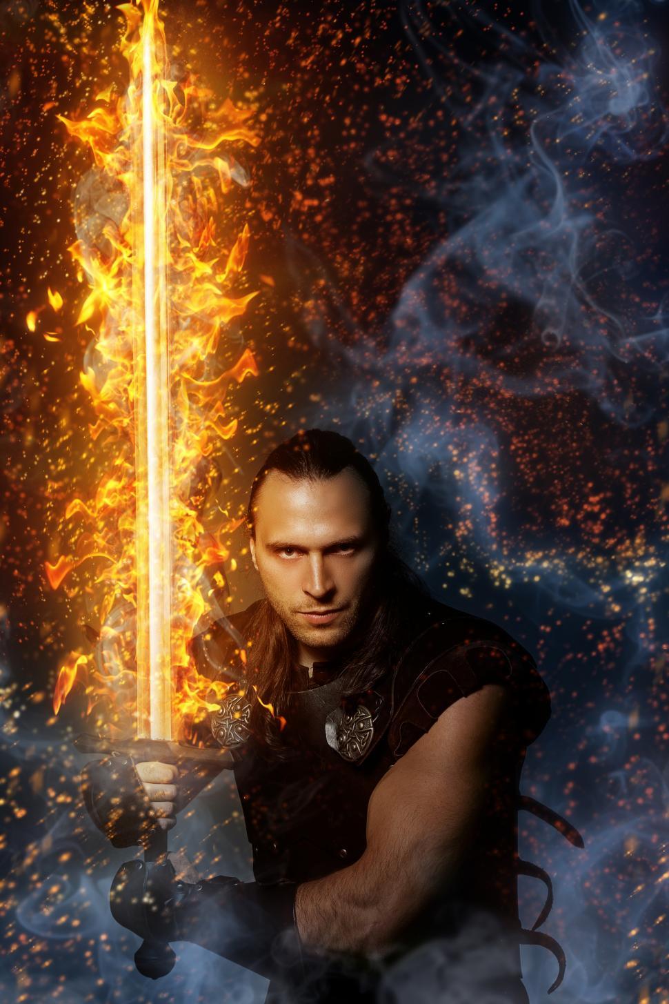 Download Free Stock Photo of Wizardry, magic. Lone warrior with fire sword 