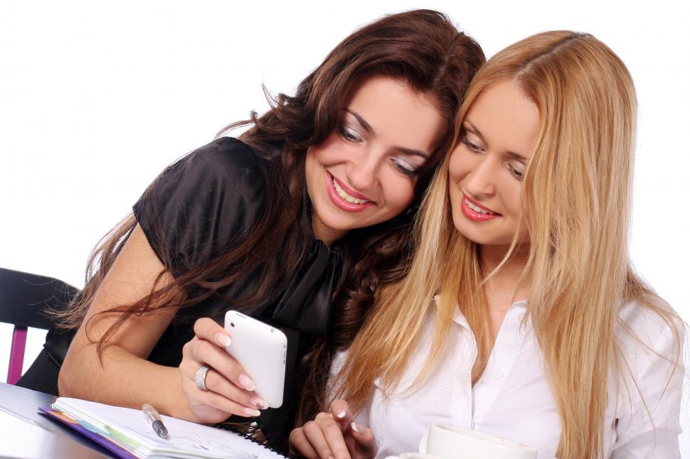 Free Image of Two friends looking at a smarphone 