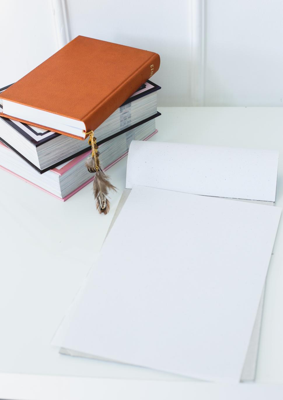 Free Image of Notepad and books on the table 