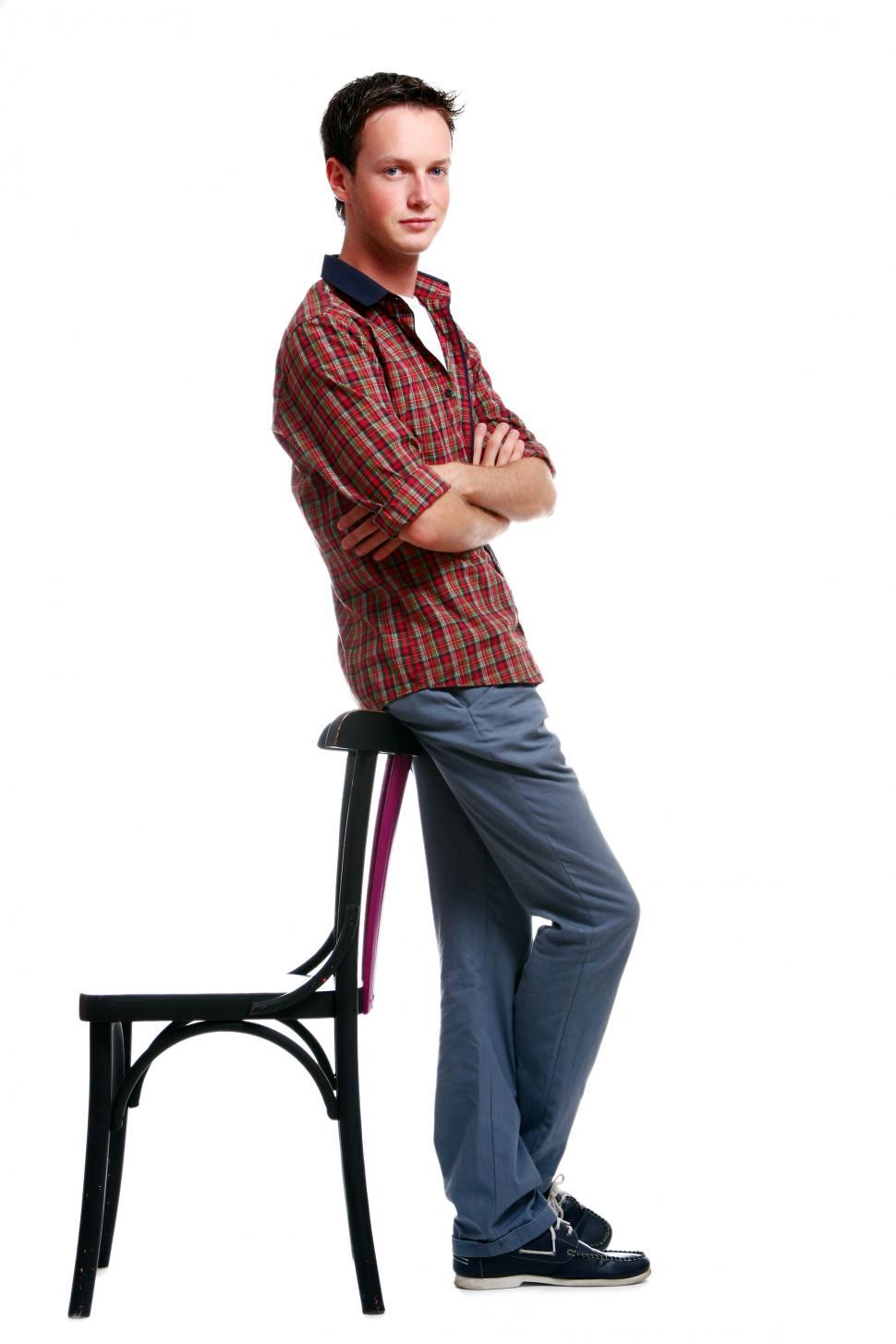 Free Image of boy on white leaning on a chair 