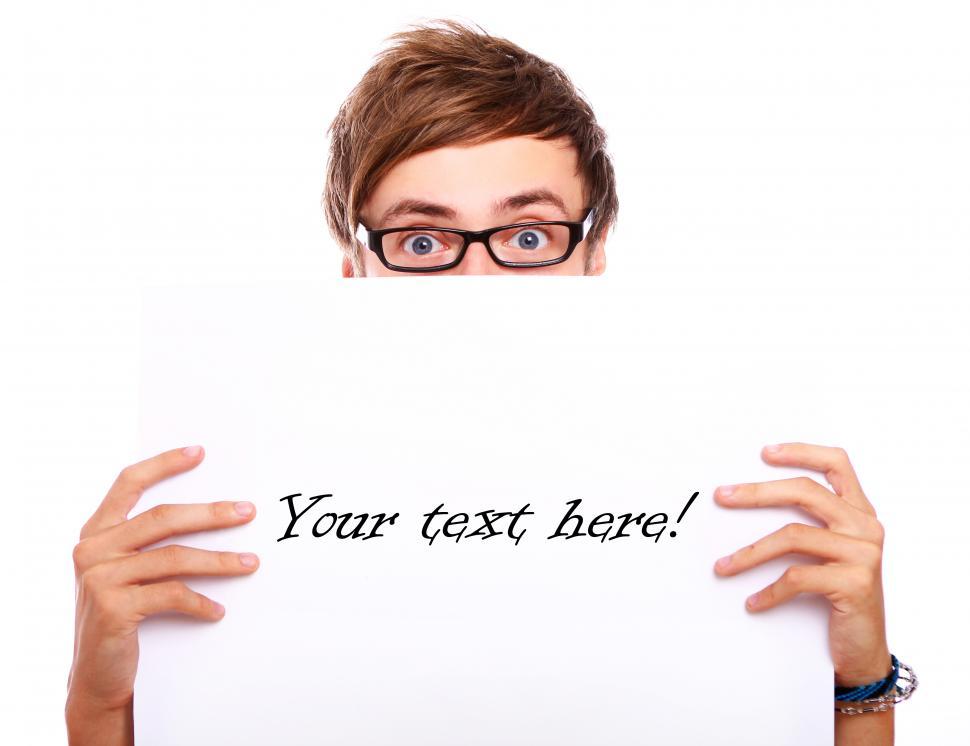 Free Image of Young guy in glasses holding blank board 