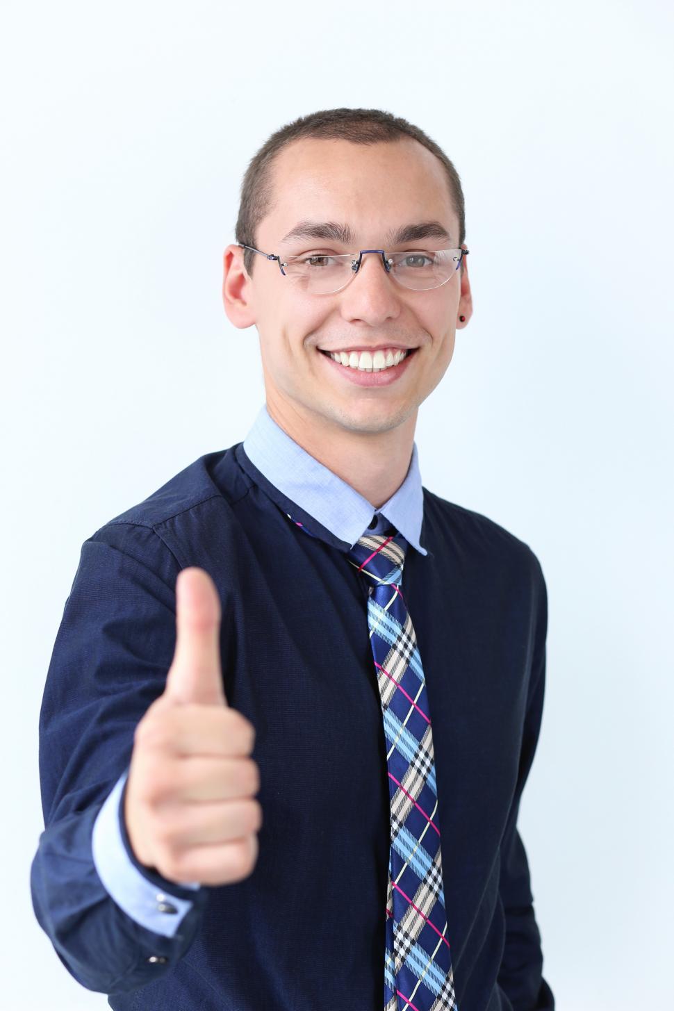 Free Image of Office. Happy guy at work gives thumbs up 
