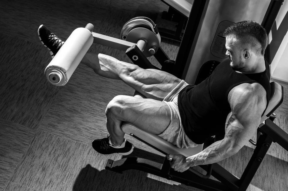 Download Free Stock Photo of Gym. Man doing leg workout. Black and white 