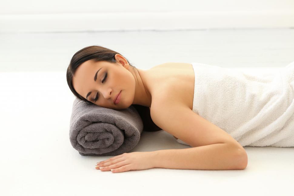 Free Image of Brunette woman on a towel after spa 