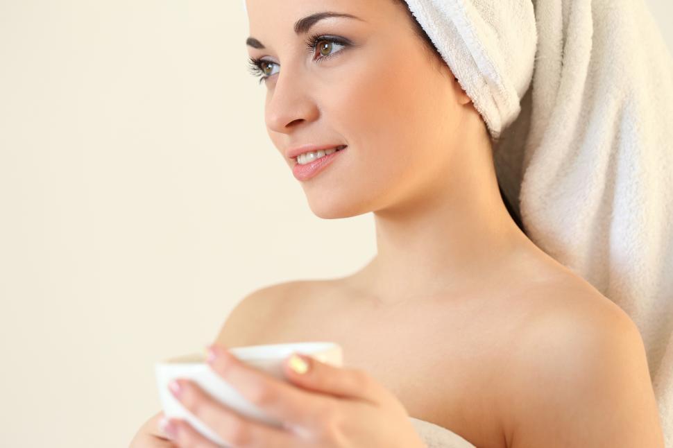 Free Image of Woman lounging with coffee after shower 