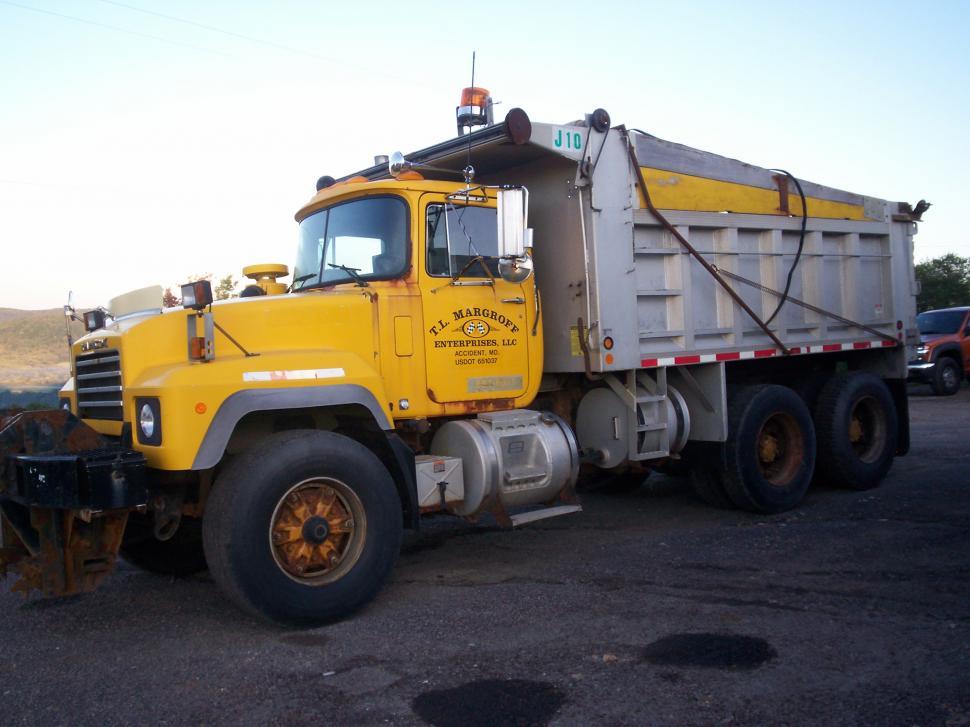 Free Image of Yellow Dump Truck Parked in Parking Lot 
