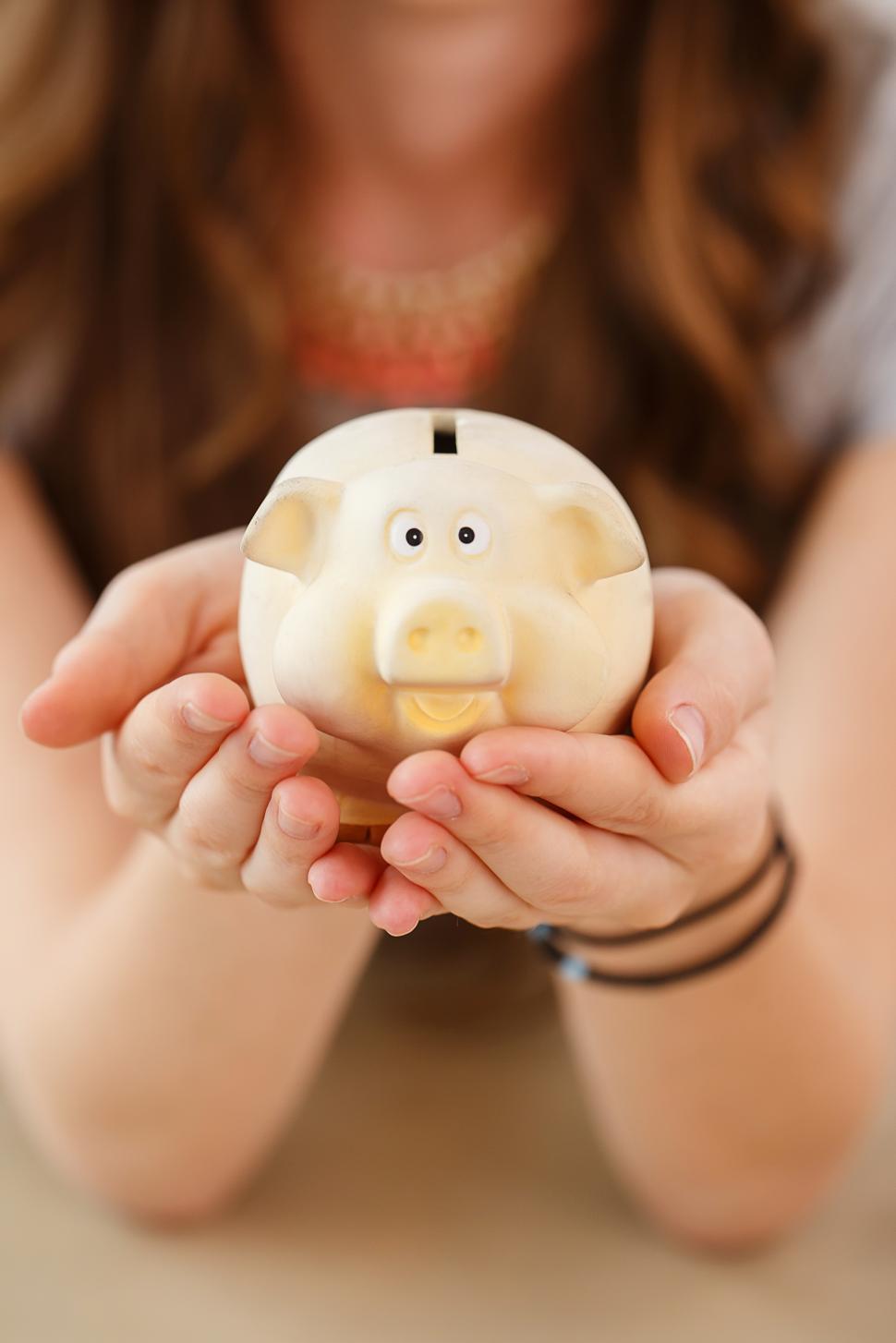 Free Image of Money, finance. Girl with piggy bank 