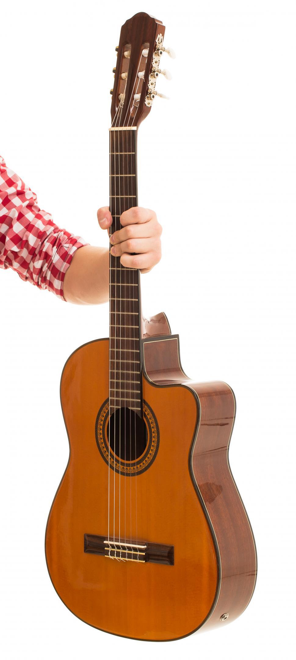Free Image of Music, close-up. Man holding an acoustic wooden guitar 
