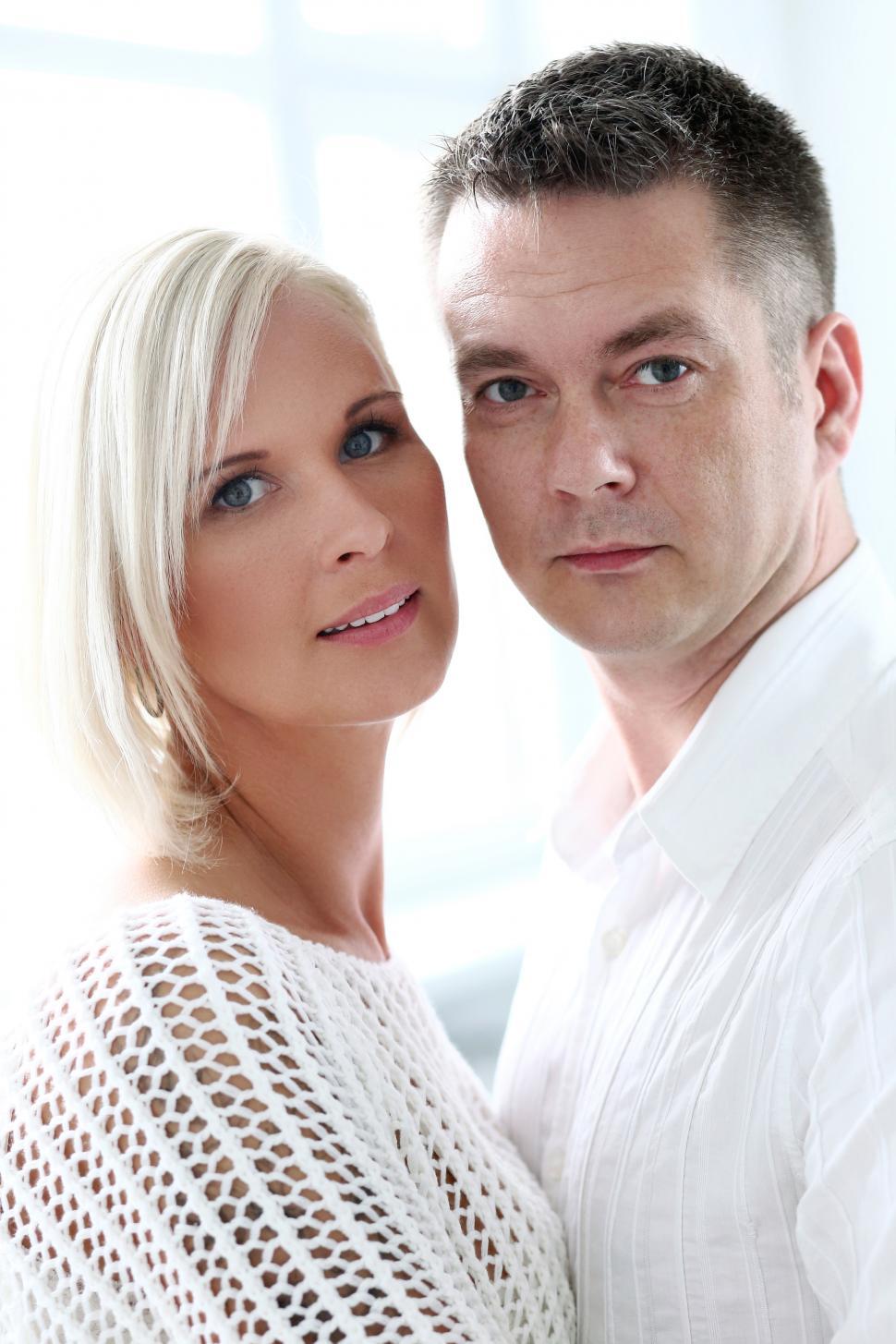 Free Image of Couple looking at the camera, white background 