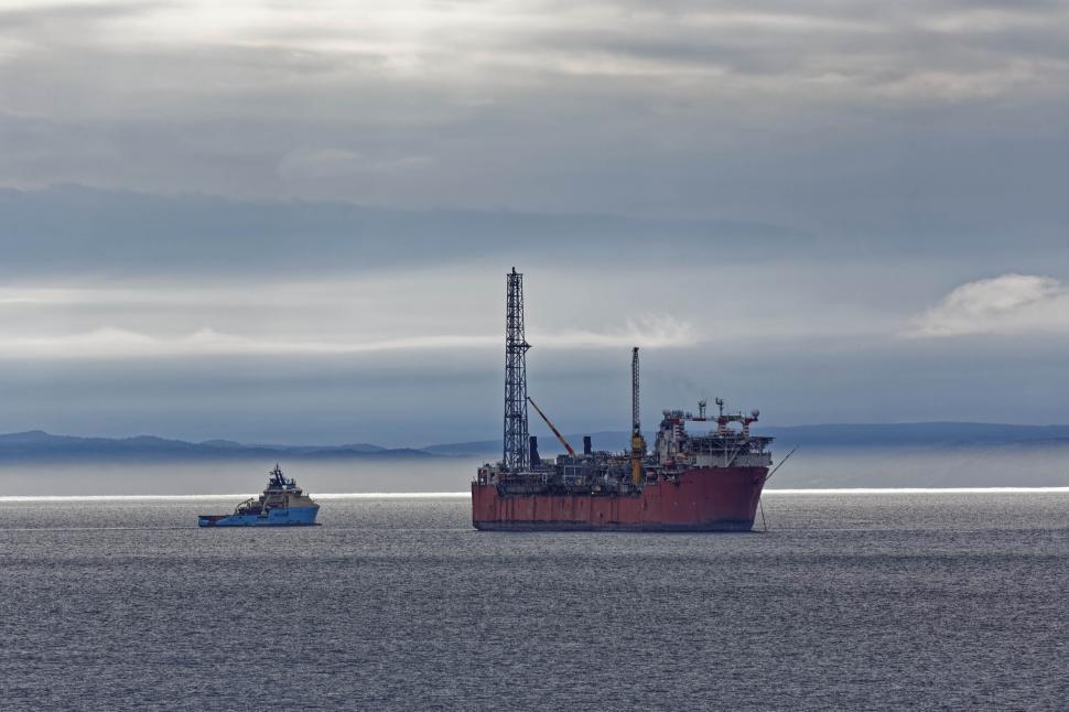 Free Image of FPSO and supply ship with cloudy sky 