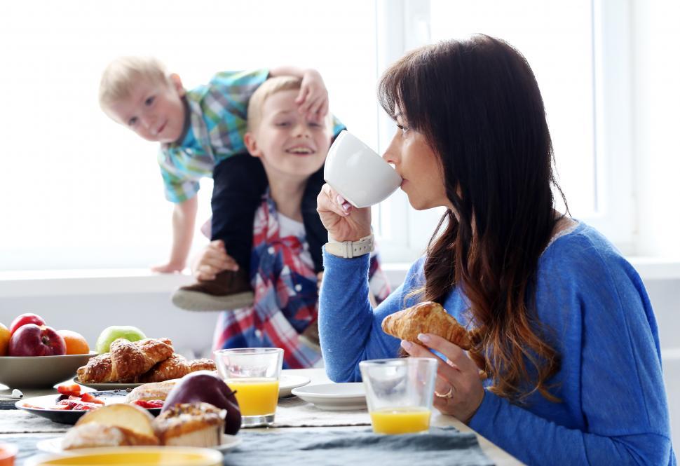 Free Image of Family chaos during breakfast, Mom and boys 