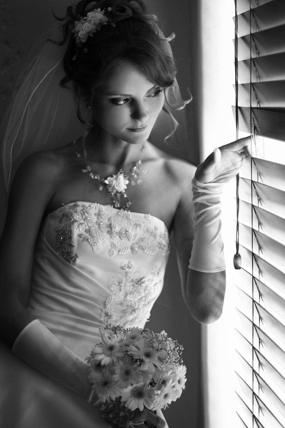 Free Image of Bride looking out a window, black and white 