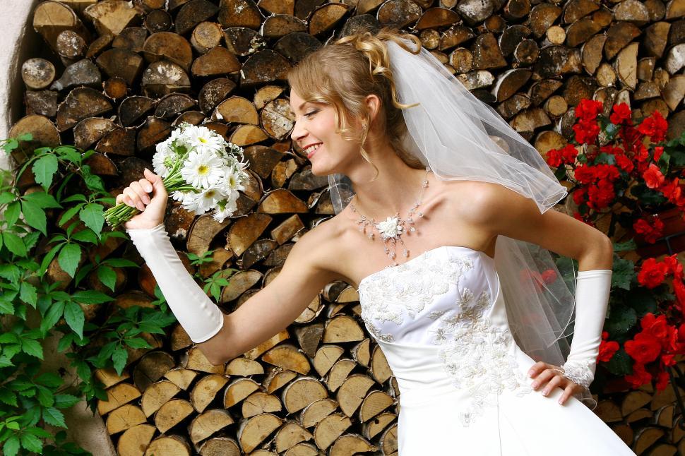 Free Image of Happy bride in wedding dress with bouquet 