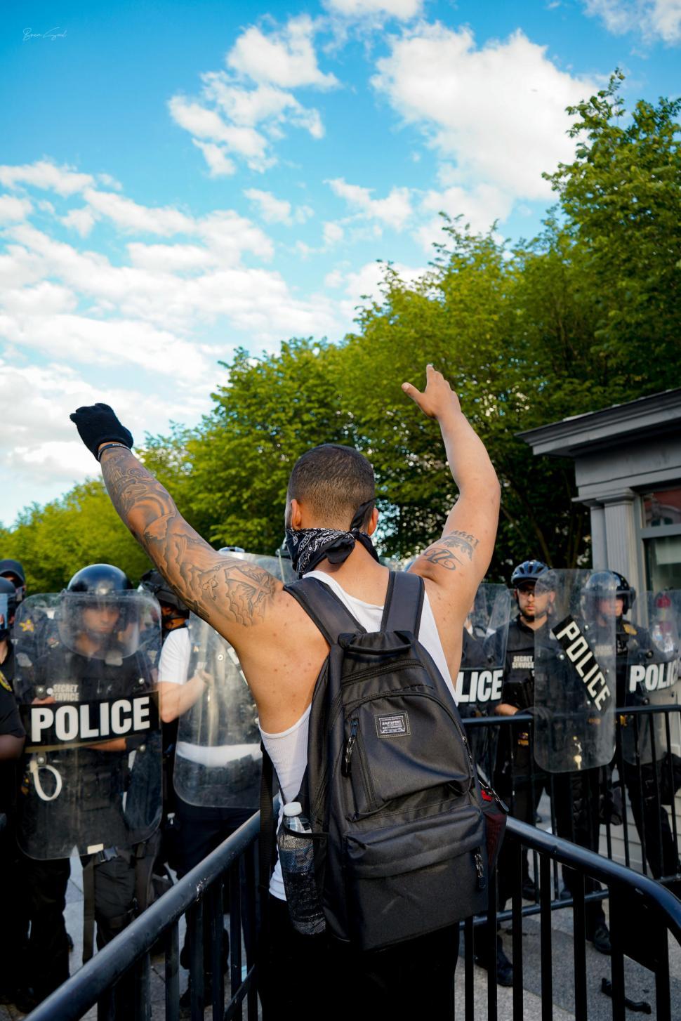 Free Image of Protester facing police line 