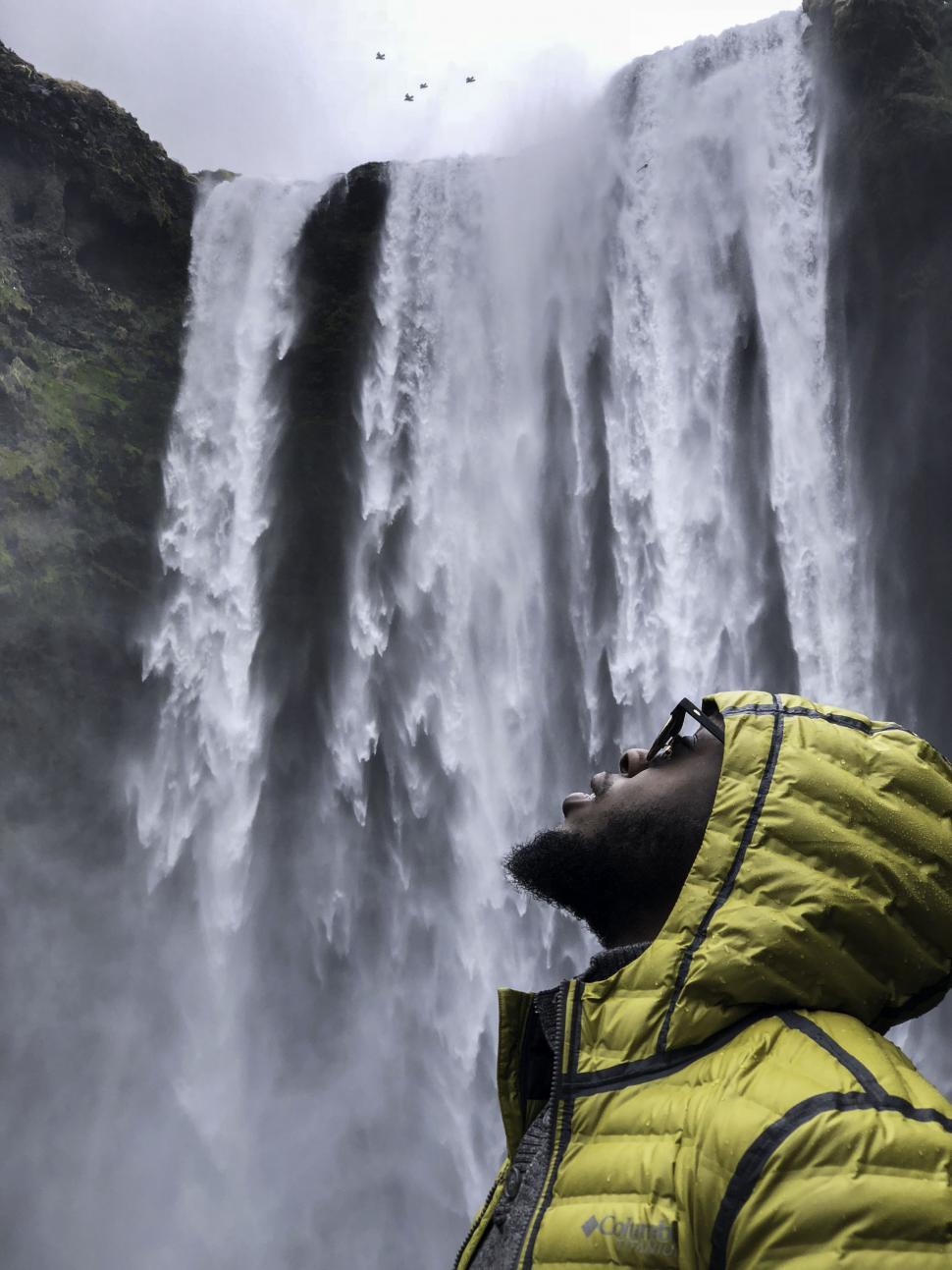 Free Image of Young Man in Winter Jacket With Waterfall 
