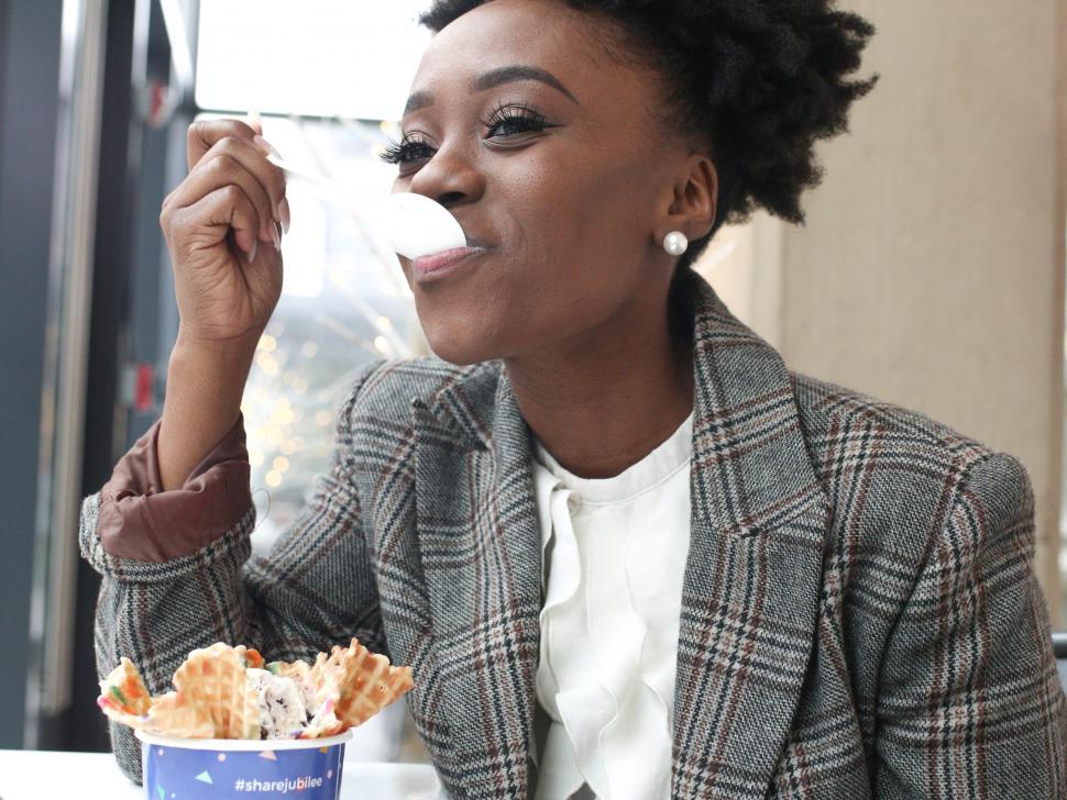 Download Free Stock Photo of Close up of Young woman in tweed blazer eating ice cream 
