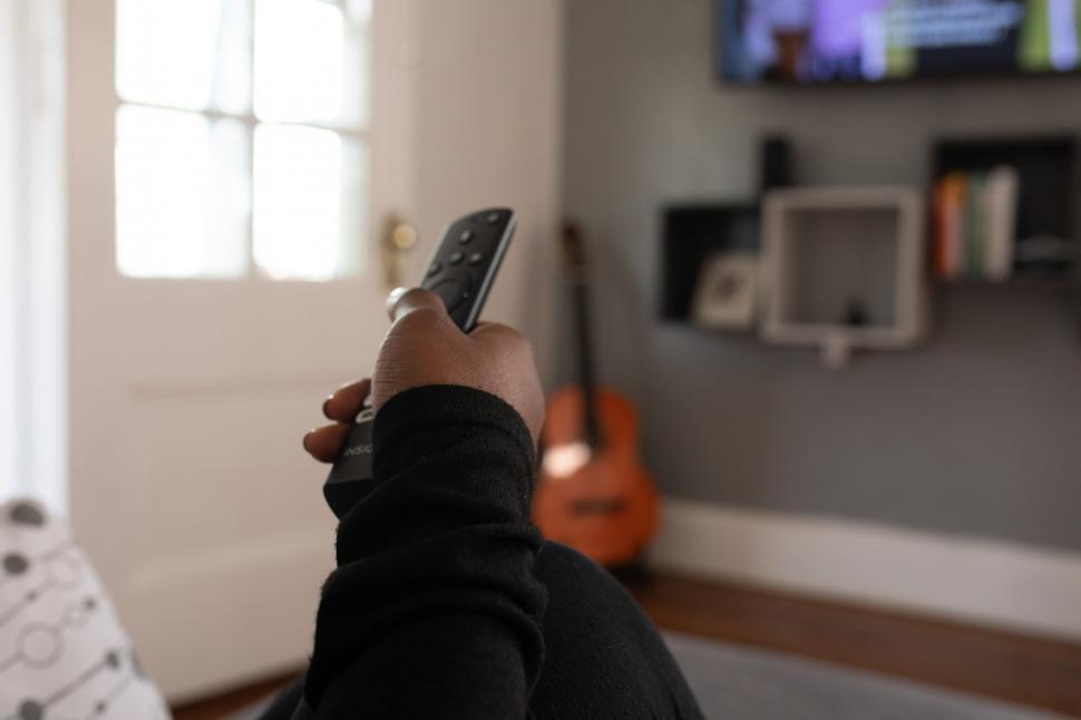 Free Image of TV Remote Control in Hand at home 